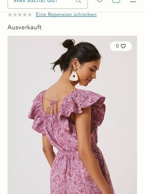 This is a mauve Kopal Myra Romper with a floral print and ruffled sleeves.